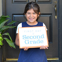 A smiling Isabella on her first day of school