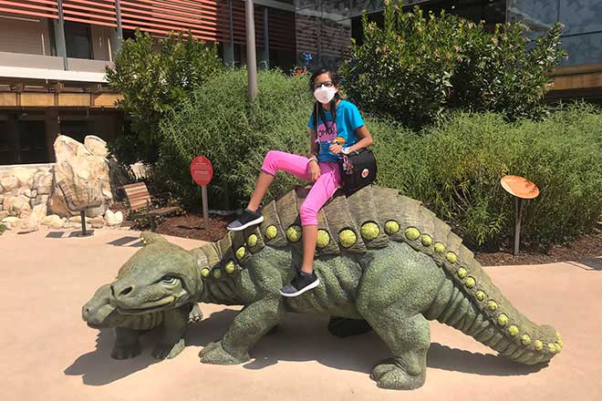 Lizneidy Serratos sitting on dinosaur